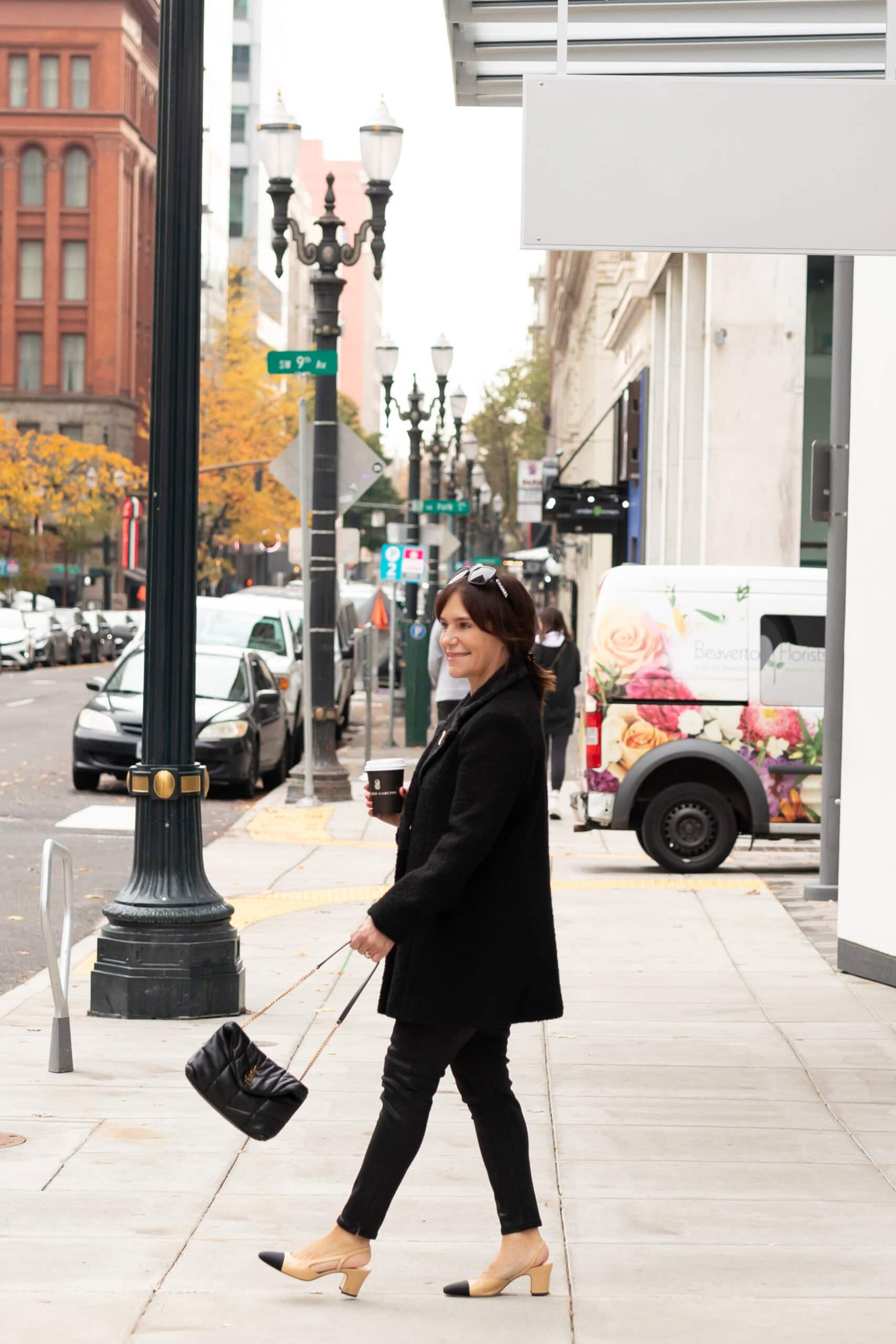 Susie weared casual winter outfit with black tweed coat, black coated skinny jeans, and Chanel slingbacks.