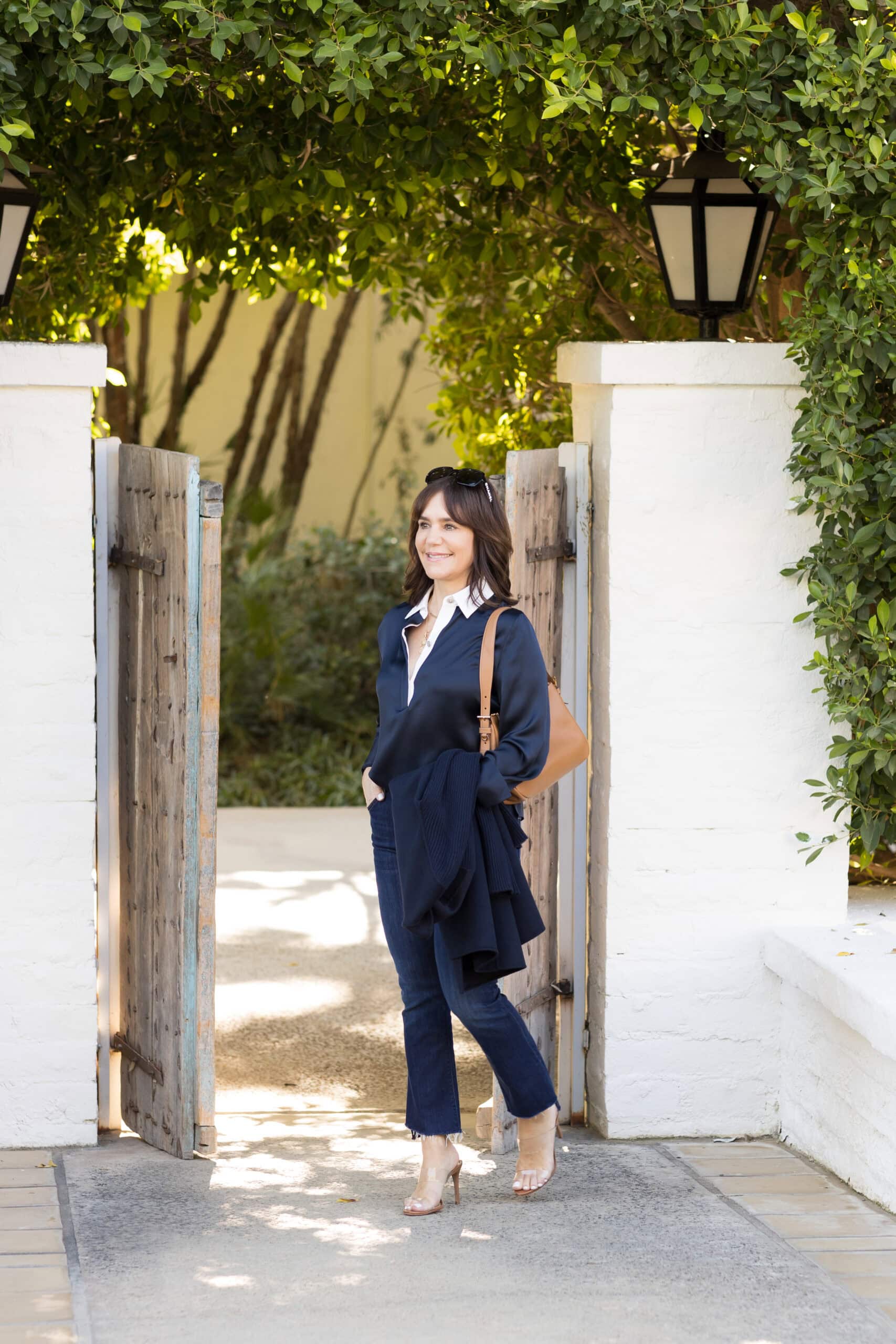 Susie wearing all navy outfit with caramel Prada shoulder bag and caramel sandals at the Parker Hotel in Palm Springs.