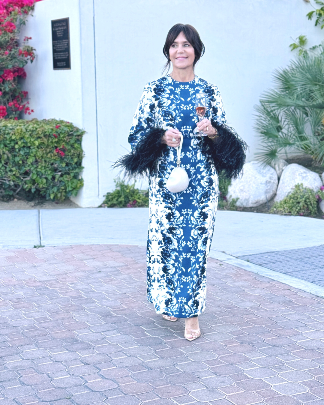 Susie in a vany/indigo printed full length dress with feathers that would be a great wedding guest dress, mother-of-the-bride dress or mother-of-the-groom dress.