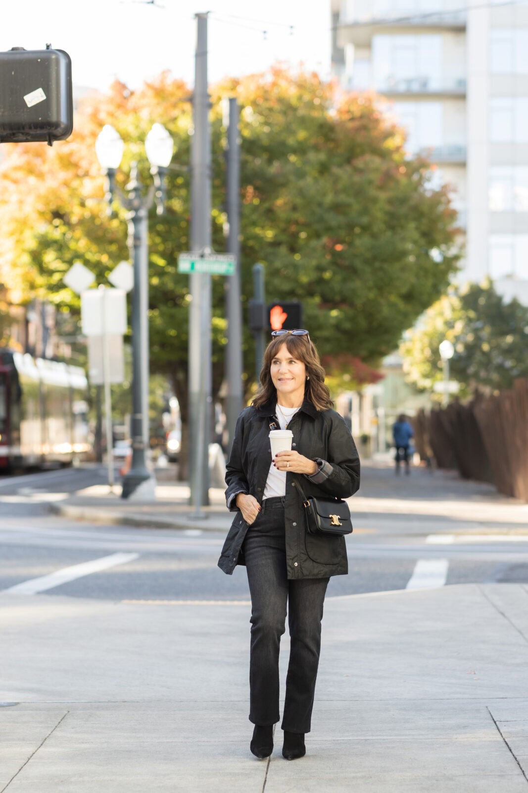 Susie wearing a Barbour barn jacket with black suede boots