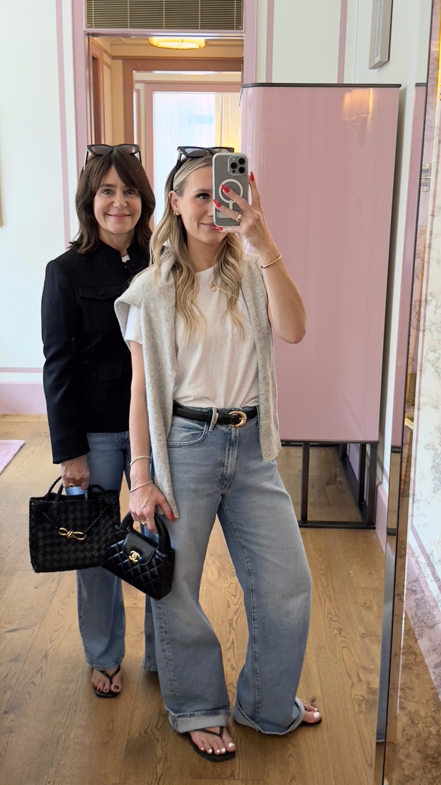 Susie and Emily shopping with black handbags, sandals, and wide leg jeans.